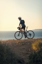 A young man enjoying a bike ride along the scenic coastal trails of Zahara de los Atunes in Cadiz