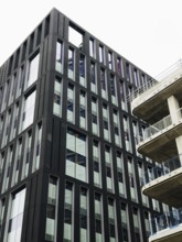 A striking modern building in London showcasing sleek lines and geometric patterns against a clear