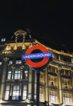 A vibrant shot of the classic London Underground sign glowing against an elegant, illuminated