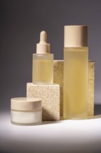 A stylish arrangement of cosmetic bottles in different sizes, showcased on textured stone podiums,