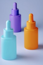 A trio of vividly colored serum bottles in purple, orange, and teal, arranged aesthetically against
