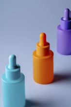 A set of brightly colored serum bottles in orange, purple, and blue against a soft blue background,