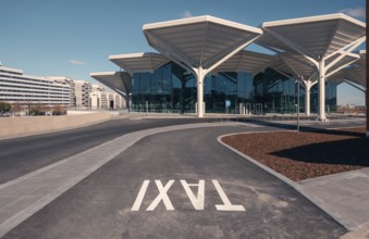 A spacious and modern transport hub in Valdebebas, Madrid, featuring a metro station, underground