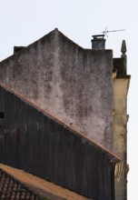A close-up shot of aging, rustic rooftops with orange tiles, contrasting with the worn and