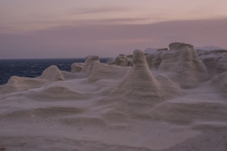 Serene evening view of the distinctive white rock formations at Sarakiniko Beach on the island of