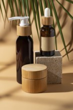 Aesthetic display of cosmetic bottles on a beige background. Featuring bamboo accents and a