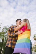 A happy lesbian couple shares a tender moment outdoors, embracing each other's love and connection.