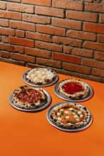 A mouthwatering assortment of pizzas featuring Margherita, Pepperoni, Four Meats, and Four Cheese.