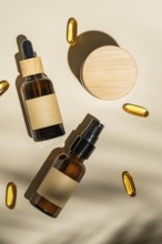 Top view of an amber glass cosmetic bottles with blank labels surrounded by soft shadows and golden