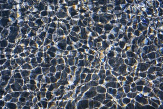 Sunlight dances on the rippling waters of Playa Blanca Port, Lanzarote, creating a mesmerizing