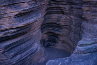 Intriguing photo capturing the detailed, layered rock formations inside Cueva de los Verdes on