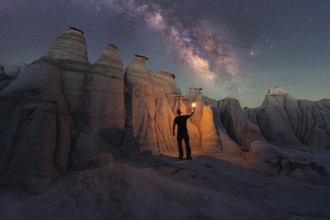 A lone figure illuminates the magnificent sandstone formations of Goblin Valley State Park, Utah,