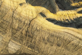 Mesmerizing aerial view of golden sandstone formations in the Utah desert, revealing intricate