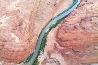 A stunning aerial shot of the Rio San Juan river weaving through the layered red rock formations in