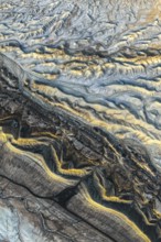 Aerial photograph showcasing the intricate golden sandstone formations of the Utah desert. The