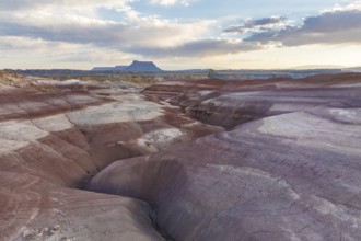 Stunning aerial shot capturing the multi-colored, layered bentonite hills in a desert landscape