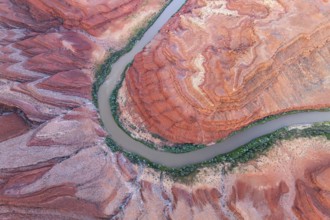 Aerial photograph of Rio San Juan meandering through the vibrant red rock formations and greenery