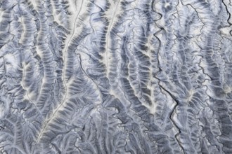 An aerial photograph showcasing the intricate, rugged textures of Moonscape Overlook, Utah,