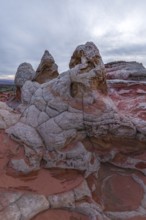 Striking rock formations characterized by intricate patterns and a mix of red and white sandstone