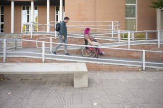 Young couple at college, featuring a woman in a wheelchair due to spina bifida The image highlights