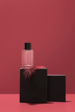 A sleek perfume bottle rests on a black stone stand, elegantly highlighted against a vibrant red