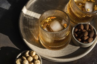 Top view of a spiced cognac-based cocktail adorned with a cinnamon and anise star, complemented by