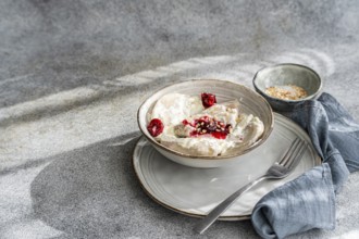 Traditional Ukrainian varenyky filled with cherries, served with rich sour cream and sprinkled with