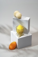 Vibrant cosmetic sponges in orange and yellow, elegantly arranged on minimalist white platforms