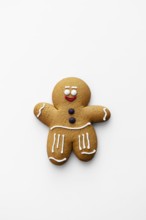 A charming gingerbread man cookie decorated with classic icing details on a white background