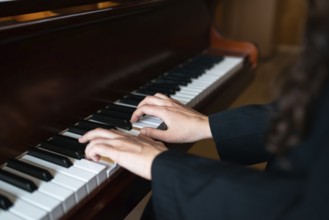 Close-up of a pianist's hands skillfully playing the piano, creating a serene and harmonious
