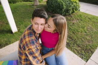 A happy lesbian couple sharing a tender moment outdoors, embracing love and diversity. Their