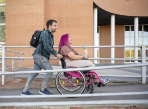 A couple at college exemplifies inclusion and accessibility The woman uses a wheelchair due to