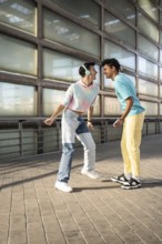 A happy couple shares a joyful moment outdoors, dressed in colorful, casual outfits. Smiling and