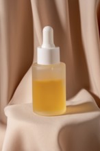 A minimalist flat lay photo featuring a glass dropper bottle of golden skincare The bottle is