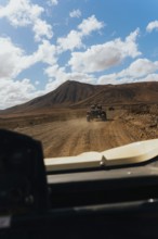 Lanzarote's rugged terrain from a buggy. Vast volcanic landscapes, scattered clouds and a scenic