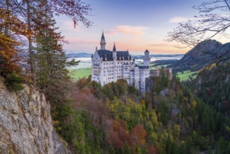 Nestled in the Bavarian Alps, Neuschwanstein Castle stands majestically amidst vibrant autumn