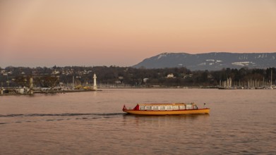 A vibrant yellow boat glides across the serene waters of Lake Geneva during a stunning sunset, with