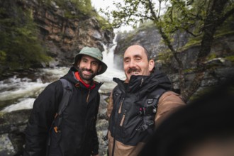 Two adventurers enjoying a scenic road trip in Norway Surrounded by lush forests and a rushing