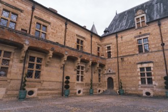 A historic Chateau Caumont castle medieval featuring arched windows and an ornate entrance in