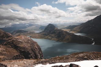 A stunning panoramic view of rugged mountain peaks and pristine lakes in Norway The dramatic