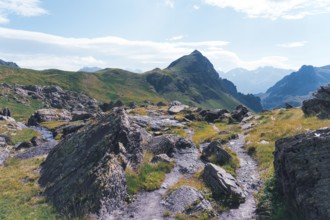 A scenic hiking trail winds through rocky terrain at the Ibones de Anayet in Huesca, Spain,