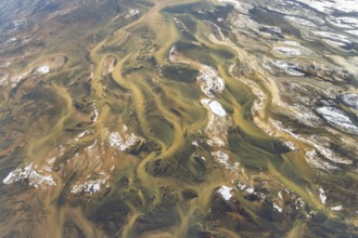 Aerial view of Iceland's rivers showcasing intricate textures and vibrant colors. The landscape