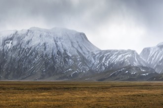 Captivating landscape of the Icelandic Highlands featuring rugged, snow-capped mountains under