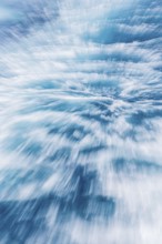 Blurred water effect creating a sense of speed and movement. The light reflections add a vibrant