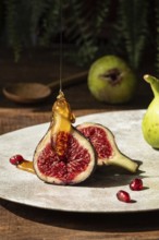 Close up of ripe figs sliced open, drizzled with golden honey. Pomegranate seeds scattered on a