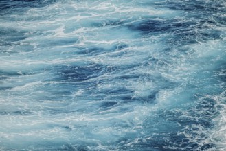 Calm water surface with soft ripples and shades of blue. A peaceful and serene moment of nature