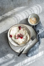 Boiled Ukrainian varenyky filled with cherry, served with a topping of sour cream and chopped nuts