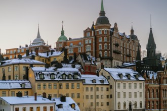 Discover the stunning architecture of Stockholm, Sweden, as the winter sun sets over snow-covered