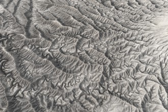 Stark aerial image showcasing the intricate, textured landforms of Caineville Mesa near Hanksville,