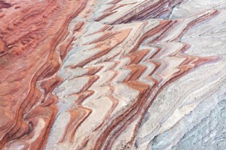 Colorful sediment patterns unfold in an aerial view of the canyon landscape near the San Juan